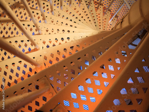 Spiral staircase design showcasing metalwork and light in an architectural setting