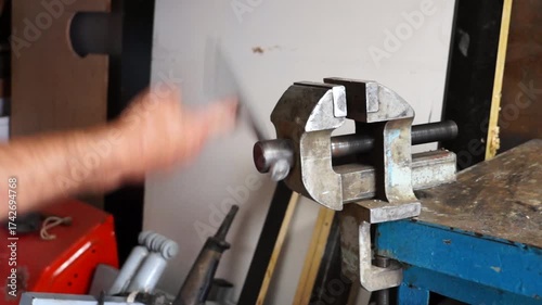 close up of a man using a hammer