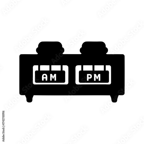 Black and white image depicting a split flap display showing AM and PM