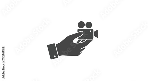 Hand holding camera icon: minimalist silhouette symbol for video and film themes
