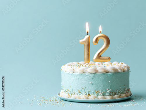 Celebration of a 12th birthday with a blue cake and golden candles