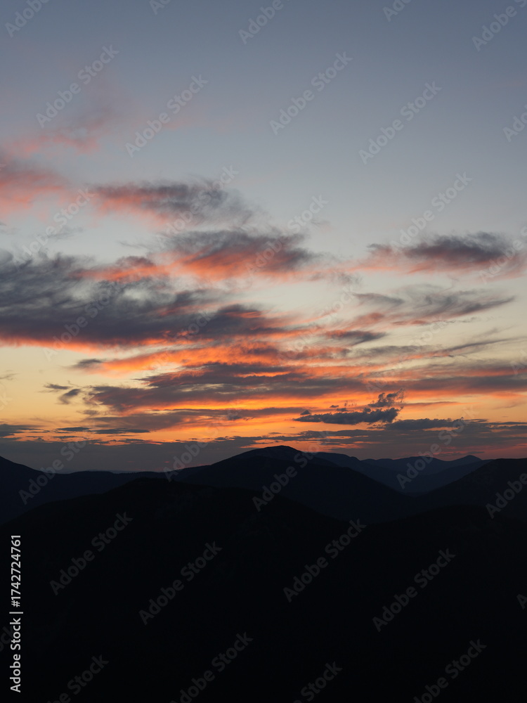 Fototapeta premium Peaceful night in the mountains — campfire, tents and starry sky