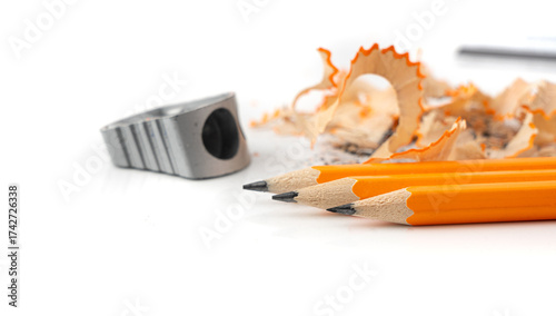 Sharpening pencils. Yellow wooden graphite pencils with erasers, pencil shavings