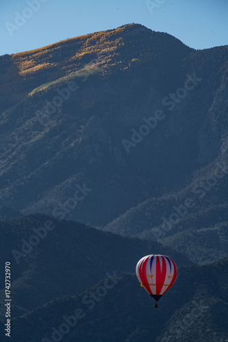 red and white balloon in front of Sandia Mountains