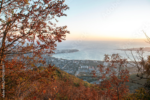 A view from a mountainside on an autumn day. A view from the observation deck of the sea and the city of Gelendzhik. Autumn in the mountains by the Black Sea.