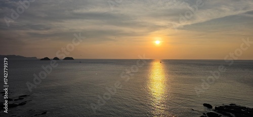 Golden sunrise over tropical island coastline horizon.in Costa Rica