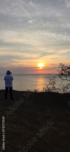 Sunset contemplation: Man overlooking a beautiful ocean horizon.in Costa Rica