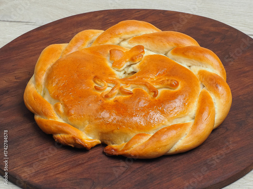 Traditional homemade baked pie with decorative crust on board
