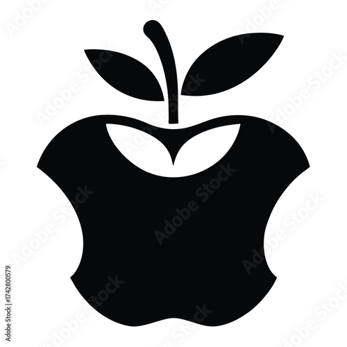 A black core of the apple with stem and leaves has been eaten