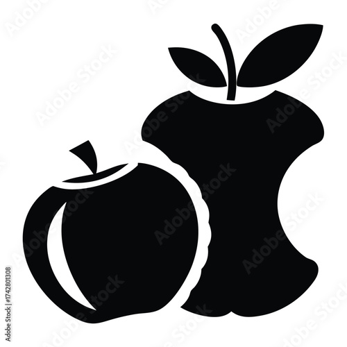 Black full apple stands beside a black apple core with leaves intact