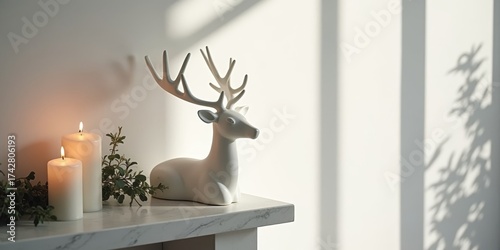 Elegant matte white ceramic reindeer sculpture on modern marble holiday mantel with candles and eucalyptus in minimalist Scandinavian interior