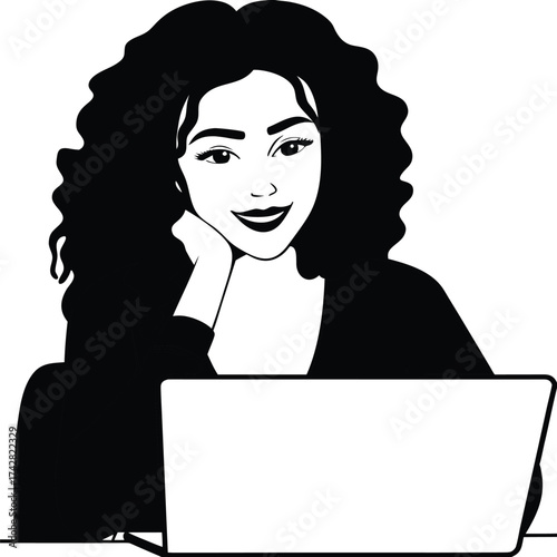 Smiling Afro American woman rests her chin on her hand in front of a laptop