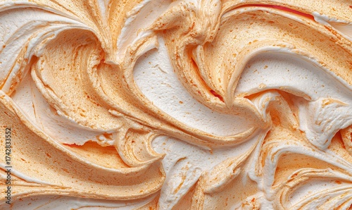 Indulgent swirls of creamy white and vibrant orange frosting create a decadent, textured background perfect for sweet treats and dessert themes