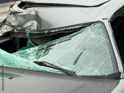 A broken windshield of a car as a result of a traffic accident. Dangerous, careless, unsafe, drunk, impaired driving, DUI, car crash fatal injury, insurance claim concept, car owner will incur losses.