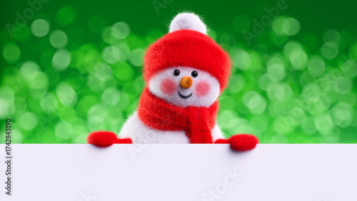 Felted wool snowman rests arms on a white surface, smiling against sparkling green bokeh. Minimal holiday background with space for text. 3d render illustration.