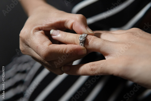 Φωτογραφία Woman removing wedding ring symbolizing divorce