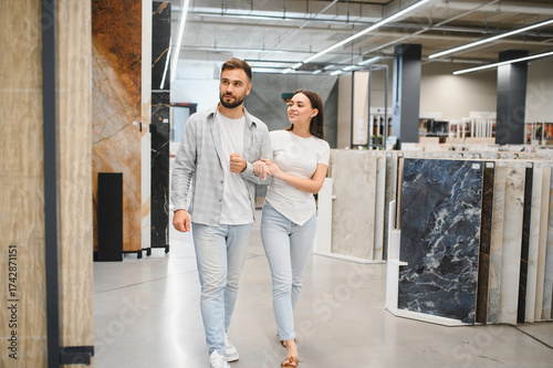 Photos Young couple choosing tiles for home renovation design
