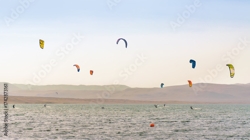 Kitesurfin in Paracas, Peru with a clear sky, summer in the beach
