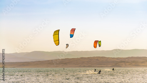 Kitesurfin in Paracas, Peru with a clear sky, summer in the beach