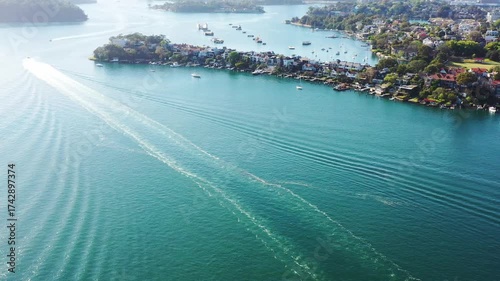 Surface of Parramatta river to distant Sydney city CBD landmarks in aerial view.