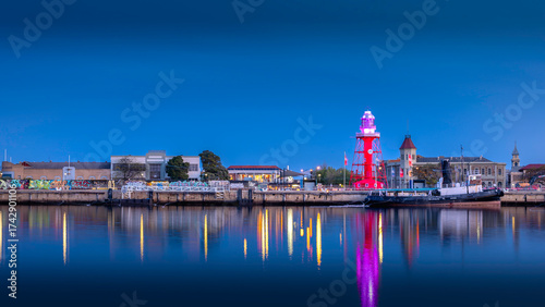 View of buildings reflecting in water in the blue hour