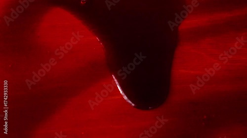 Slow flow of thick red blood. Slow movement.Red blood wallpaper.Criminal symbol.Halloween wallpaper. 4k footage