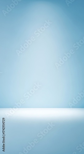 Empty light blue studio background with a white floor and subtle spotlight, perfect for product display or abstract concepts.