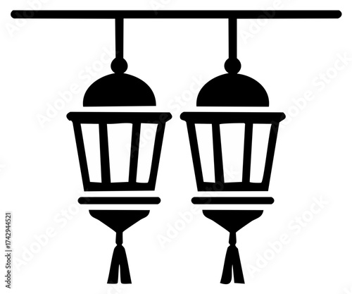 Two traditional lanterns hanging from a horizontal bar with tassels