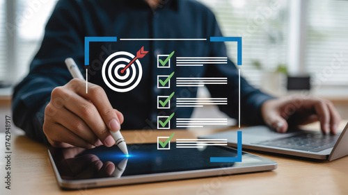 Professional man using digital tablet to check off tasks on list, target achieved, modern work environment, for business planning and goal success