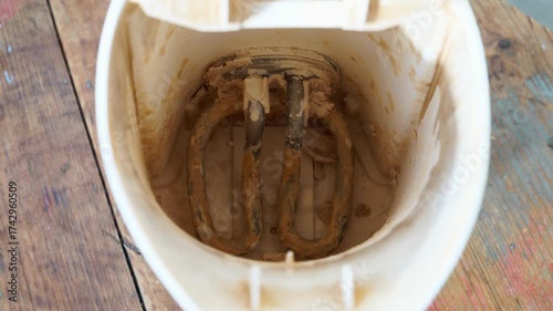 Wallpaper Mural A detailed close-up view of an electric kettle's heating spiral, visibly encrusted with significant limescale deposits. This highlights the common issue of hard water buildup in household appliances. Torontodigital.ca