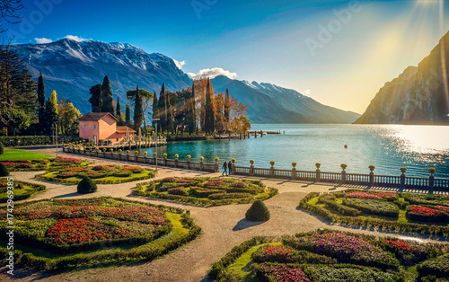 View of beautiful Lake Garda surrounded by mountains, Panoramic autumn view of sunset over Lake Garda in the evening with beautiful sunset colors, Italy