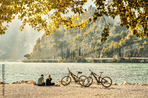 View of beautiful Lake Garda surrounded by mountains, Panoramic autumn view of sunset over Lake Garda in the evening with beautiful sunset colors, Italy