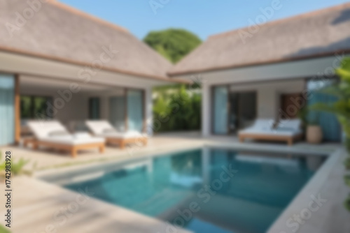 Wallpaper Mural Blurred background of a modern swimming pool with lounge chairs beside it for visitors to relax, with a charming sunset. Torontodigital.ca