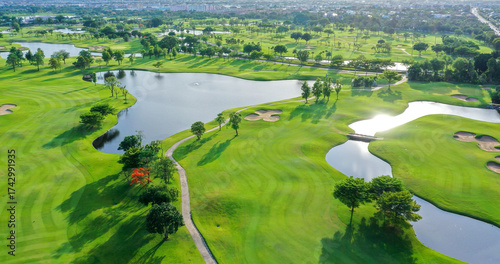 Golf course sport, green grass and trees on a golf field, fairway and putting green top view. Golf course with a rich green turf beautiful scenery.	