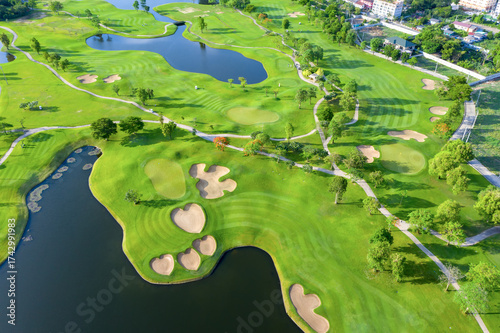 Golf course sport, green grass and trees on a golf field, fairway and putting green top view. Golf course with a rich green turf beautiful scenery.	