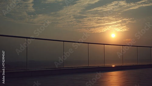 Sunset glow on glass railing, hazy sky, city background
