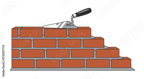Brick wall under construction with a bricklayer's trowel tool resting on top, a concept for building, development, and masonry projects
