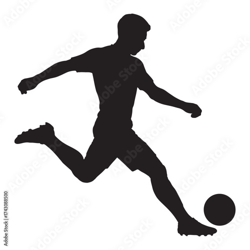 Silhouette of a soccer player kicking a ball action shot