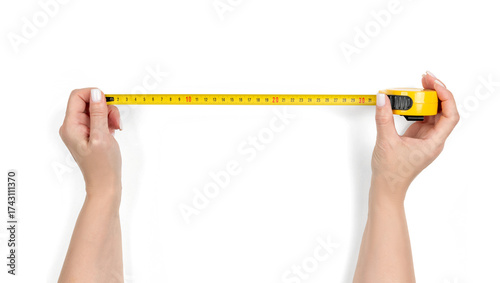 Woman hands holding a yellow measuring tape, isolated object with transparent background PNG, accurate measuring tool for DIY, construction, home renovation or sewing projects