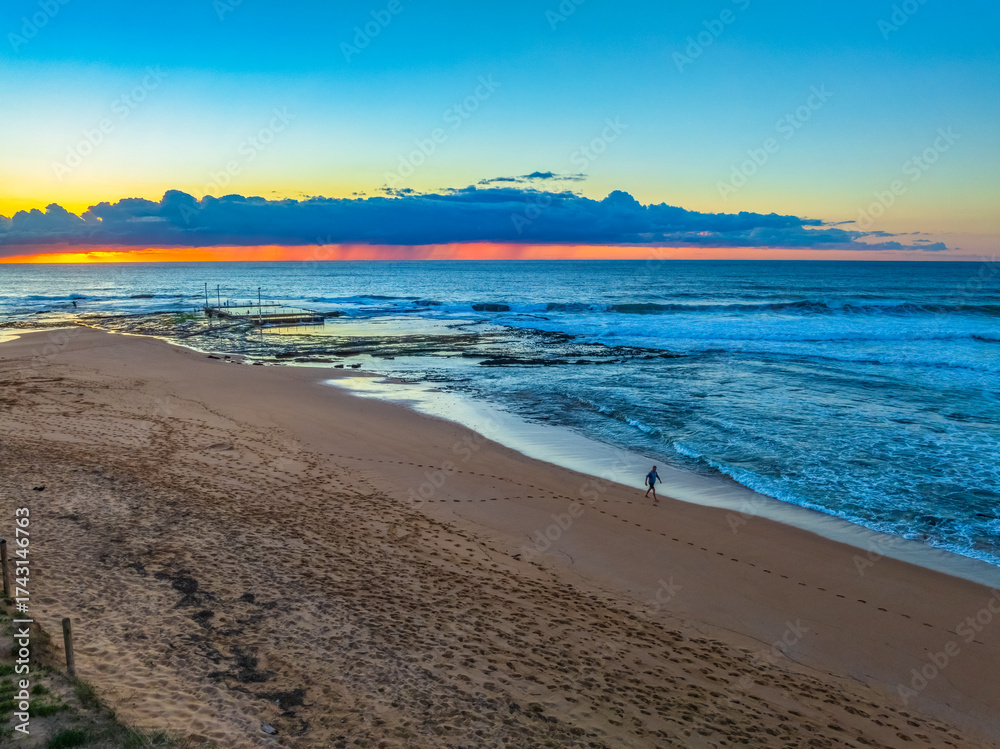 Obraz premium Sunrise at the beach with low cloud bank