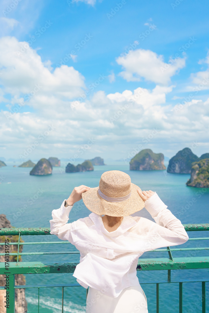 Fototapeta premium Woman tourist traveling in Krabi, Thailand. happy traveller enjoy and sightseeing view at koh Hong island viewpoint. summer trip, destination, Southeast Asia Travel, vacation and holiday concept