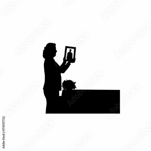 Silhouette of a woman holding a photo frame remembering someone lost isolated on white background