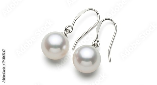 Two lustrous white pearl drop earrings with silver-colored hooks on a white background