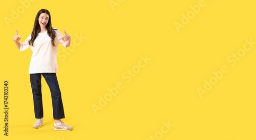 Happy young woman pointing ...