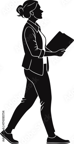 Businesswoman walking with documents in silhouette