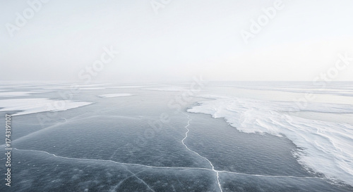 Frozen lake surface with cracks and snow, creating a serene and icy winter landscape with a sense of coldness and vastness