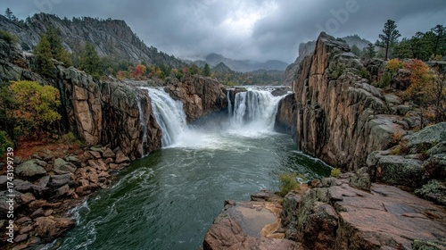 Majestic Waterfall Cascading Down Rocky Cliffs in a Cloudy Autumn Landscape.

Category Landscapes