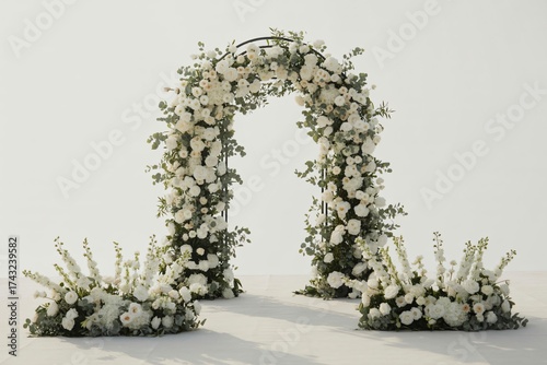 Elegant wedding arch adorned with white flowers and greenery against a bright white background scene setup