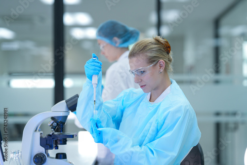 Принти на полотні In a bio manufacturing facility, scientists develop a personalized mRNA vaccine, using a digital tablet to guide the precise formulation for a next generation gene therapy treatment