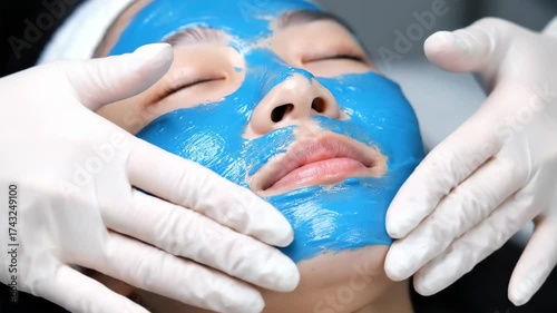Young Woman Receives Blue Algae Facial Mask Treatment.